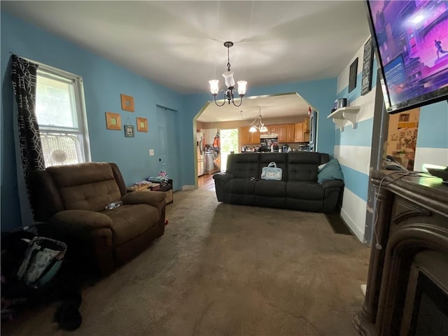 22 Jefferson St, North Dansville, NY 14437 - living room featuring a chandelier, carpet flooring, and arched walkways