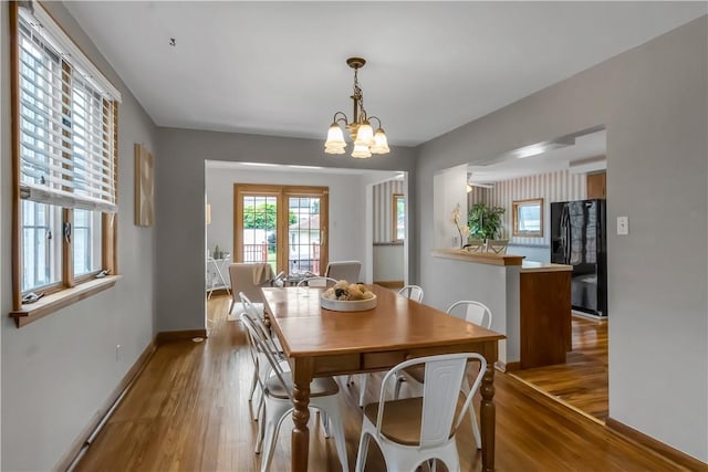 128 Princeton Blvd, Tonawanda, NY 14217 - dining area with wood finished floors and a chandelier