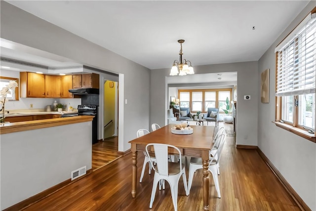 128 Princeton Blvd, Tonawanda, NY 14217 - dining area with dark wood-type flooring and a chandelier