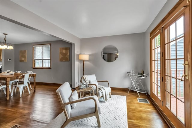 128 Princeton Blvd, Tonawanda, NY 14217 - sitting room with wood finished floors and a chandelier