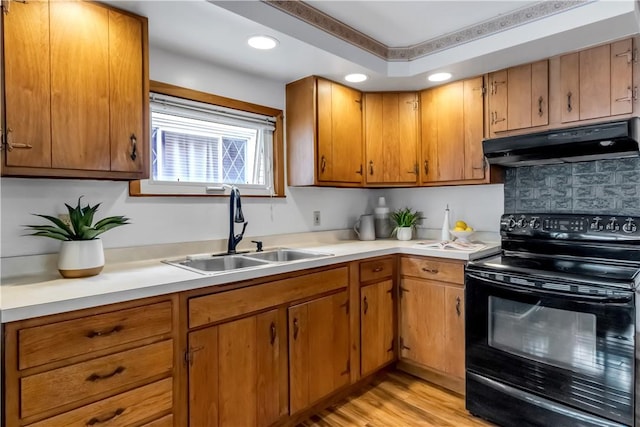 128 Princeton Blvd, Tonawanda, NY 14217 - kitchen featuring black range with electric stovetop, under cabinet range hood, light countertops, backsplash, and light wood finished floors
