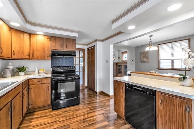 128 Princeton Blvd, Tonawanda, NY 14217 - kitchen with black appliances, under cabinet range hood, wood finished floors, light countertops, and recessed lighting