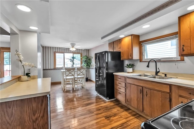 128 Princeton Blvd, Tonawanda, NY 14217 - kitchen featuring black fridge with ice dispenser, brown cabinets, healthy amount of natural light, wallpapered walls, and recessed lighting