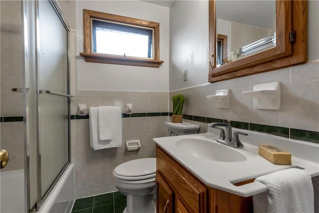 128 Princeton Blvd, Tonawanda, NY 14217 - full bath featuring tile patterned floors, tile walls, vanity, and combined bath / shower with glass door