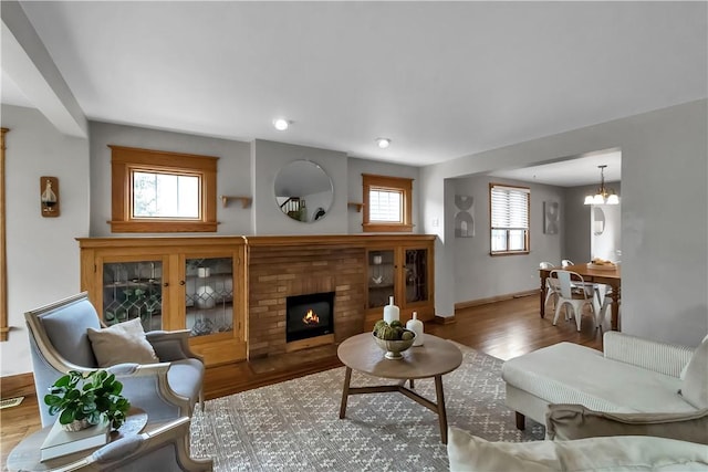 128 Princeton Blvd, Tonawanda, NY 14217 - living room with a brick fireplace, wood finished floors, plenty of natural light, and recessed lighting