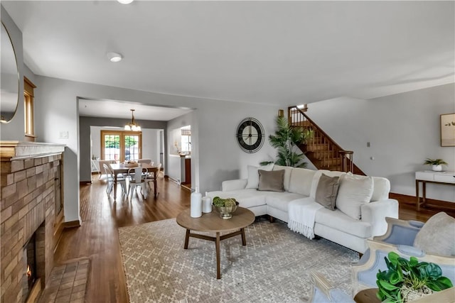 128 Princeton Blvd, Tonawanda, NY 14217 - living area featuring dark wood-style floors, stairway, and a brick fireplace