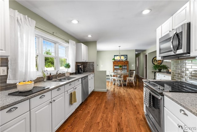 102 W Rand St, German Flatts, NY 13357 - kitchen featuring stainless steel appliances, decorative backsplash, white cabinets, recessed lighting, and dark wood-type flooring