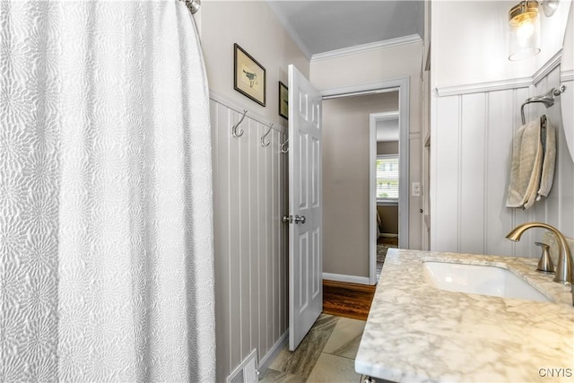 102 W Rand St, German Flatts, NY 13357 - bathroom featuring ornamental molding, vanity, and a decorative wall