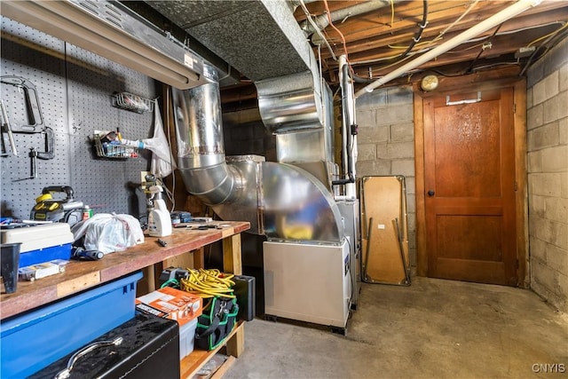 102 W Rand St, German Flatts, NY 13357 - unfinished below grade area featuring concrete block wall, a workshop area, and heating unit