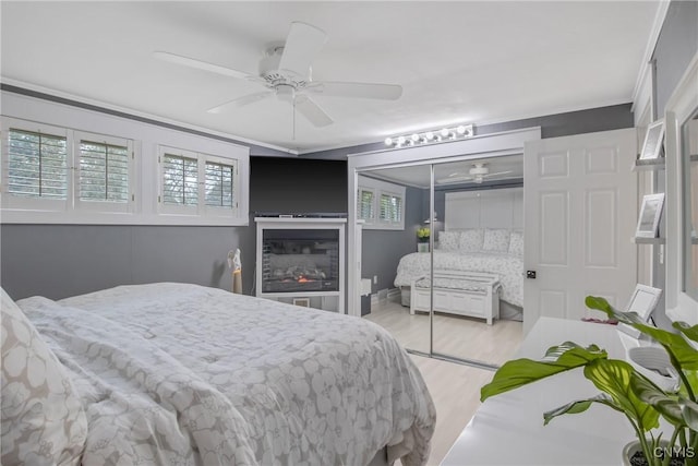 207 Baxton St, Clay, NY 13212 - bedroom featuring light wood-style flooring, multiple windows, a closet, a ceiling fan, and ornamental molding
