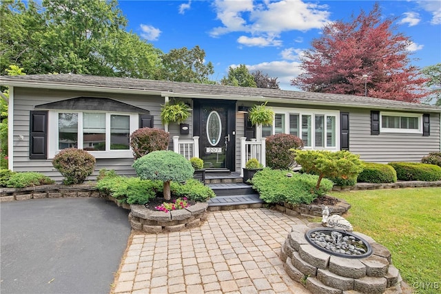 207 Baxton St, Clay, NY 13212 - view of front facade with a front lawn, a shingled roof, and a fire pit