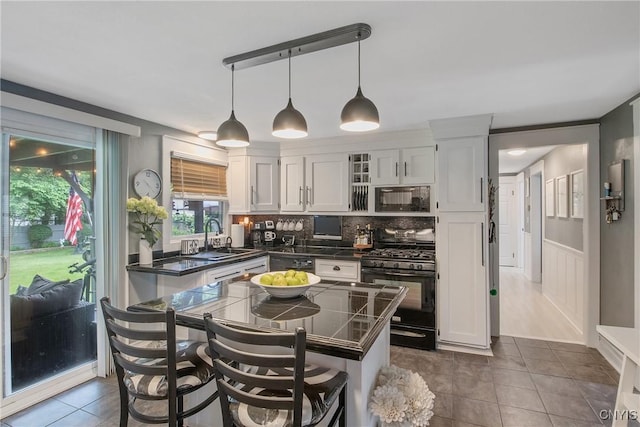 207 Baxton St, Clay, NY 13212 - kitchen with black appliances, dark countertops, dark tile patterned flooring, tasteful backsplash, and white cabinetry