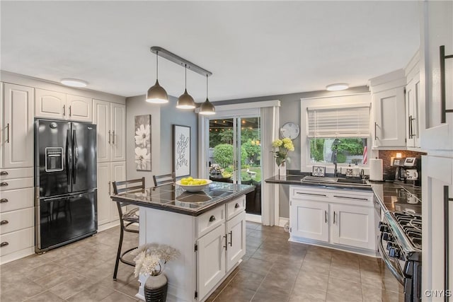 207 Baxton St, Clay, NY 13212 - kitchen featuring black appliances, dark countertops, and white cabinetry
