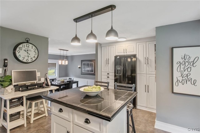 207 Baxton St, Clay, NY 13212 - kitchen featuring tile counters, black fridge, white cabinetry, tile patterned floors, and pendant lighting