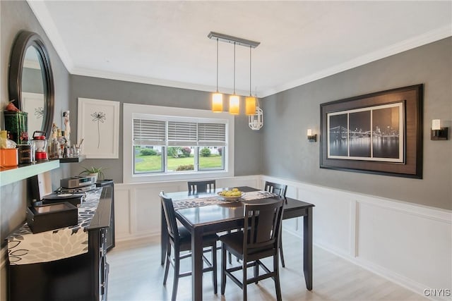207 Baxton St, Clay, NY 13212 - dining space with light wood-style floors, ornamental molding, a decorative wall, and wainscoting