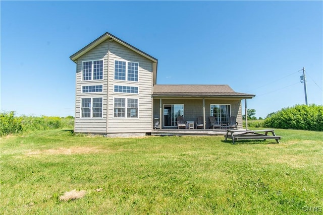 1812 Grenadier Island Rd Unit 1, Cape Vincent, NY 13618 - rear view of house with a lawn and a patio area