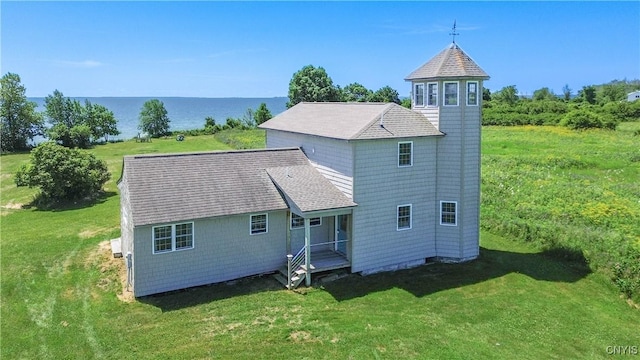 1812 Grenadier Island Rd Unit 1, Cape Vincent, NY 13618 - back of property featuring a lawn, a water view, and roof with shingles