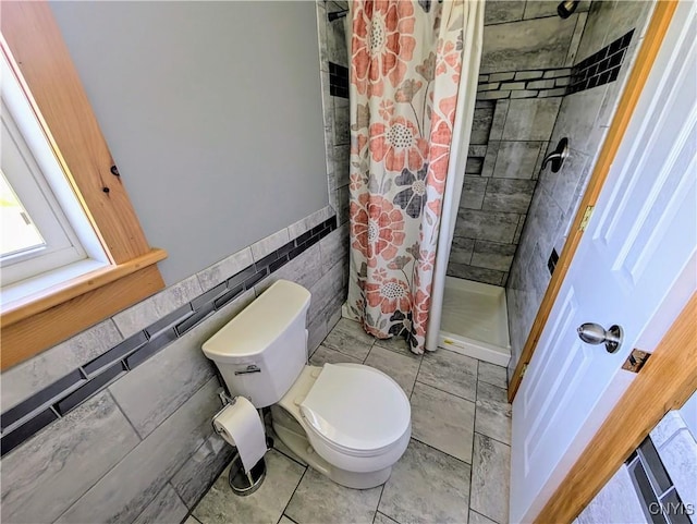 1812 Grenadier Island Rd Unit 1, Cape Vincent, NY 13618 - full bathroom featuring a stall shower, tile walls, and wainscoting