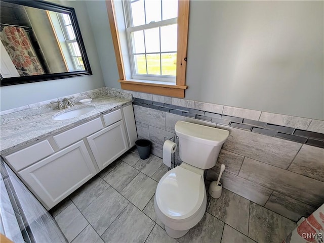 1812 Grenadier Island Rd Unit 1, Cape Vincent, NY 13618 - full bathroom featuring tile walls, vanity, a wainscoted wall, and tile patterned floors