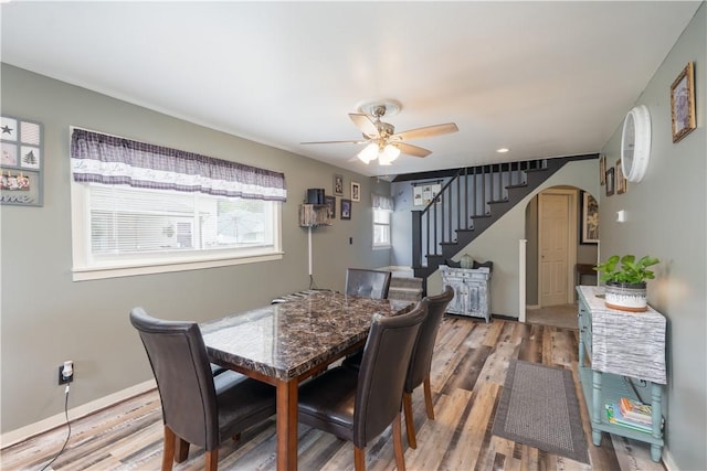 82 Maple St, Canisteo, NY 14823 - dining area with arched walkways, stairs, a ceiling fan, and wood finished floors