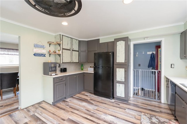 82 Maple St, Canisteo, NY 14823 - kitchen featuring freestanding refrigerator, crown molding, light wood-style flooring, gray cabinets, and tasteful backsplash