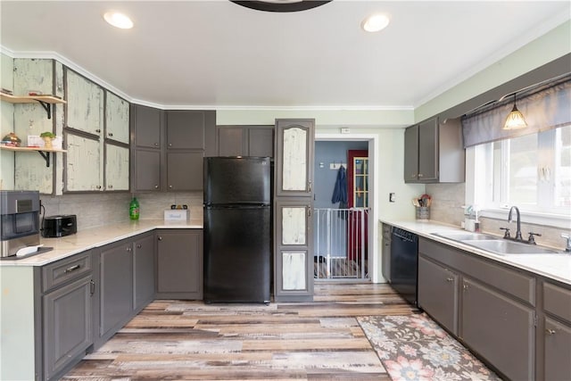 82 Maple St, Canisteo, NY 14823 - kitchen with black appliances, light wood-style floors, ornamental molding, decorative backsplash, and light countertops