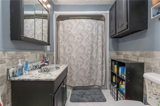 82 Maple St, Canisteo, NY 14823 - full bathroom with tile walls, vanity, wainscoting, a shower with curtain, and tile patterned floors