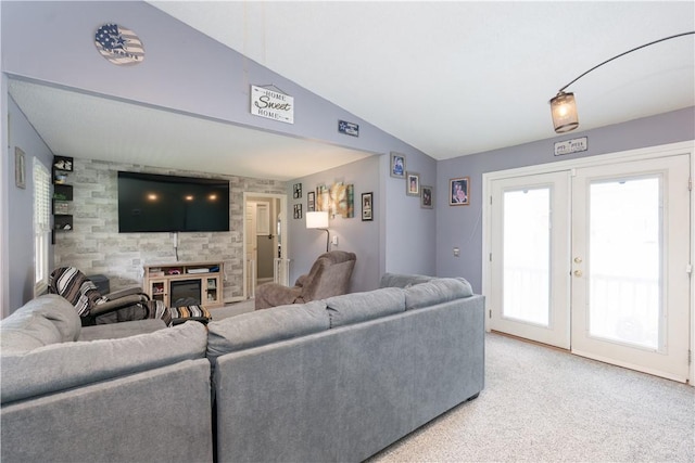82 Maple St, Canisteo, NY 14823 - living area with carpet flooring, french doors, vaulted ceiling, and a glass covered fireplace