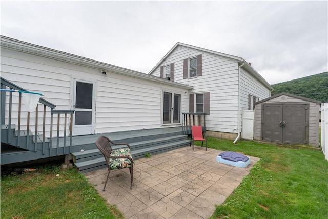 82 Maple St, Canisteo, NY 14823 - back of property featuring a storage shed, a patio area, a wooden deck, and a yard