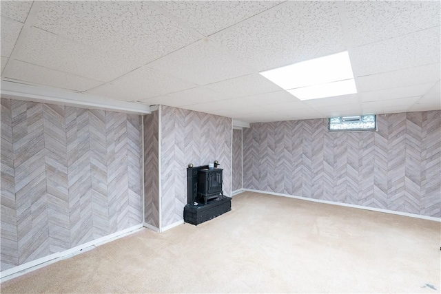 82 Maple St, Canisteo, NY 14823 - finished below grade area with a wood stove, a drop ceiling, and carpet