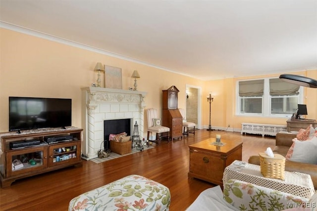 83 Bryant # 7Ab, Buffalo, NY 14209 - living room featuring wood finished floors, a tiled fireplace, crown molding, and radiator