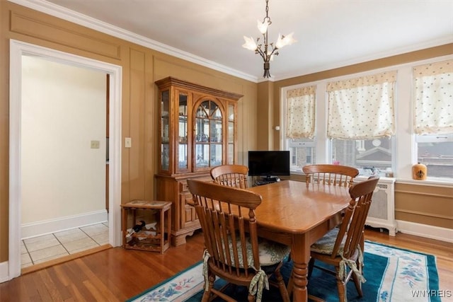 83 Bryant # 7Ab, Buffalo, NY 14209 - dining room with a chandelier, crown molding, and wood finished floors