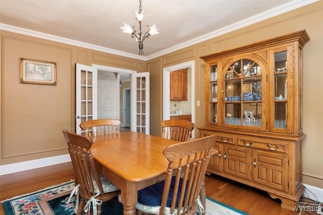 83 Bryant # 7Ab, Buffalo, NY 14209 - dining space with a chandelier, wood finished floors, french doors, and crown molding