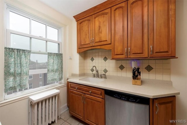 83 Bryant # 7Ab, Buffalo, NY 14209 - kitchen with stainless steel dishwasher, radiator, brown cabinetry, tasteful backsplash, and light countertops