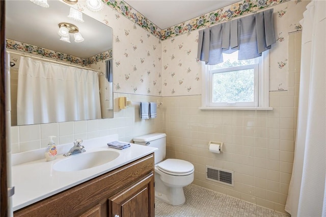 668 Willow Ln, Webster, NY 14580 - full bathroom with wallpapered walls, vanity, wainscoting, tile patterned floors, and tile walls