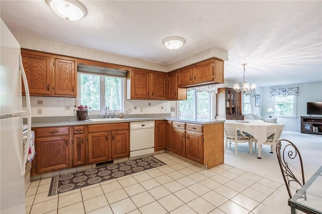 668 Willow Ln, Webster, NY 14580 - kitchen featuring white appliances, light countertops, open floor plan, and brown cabinets