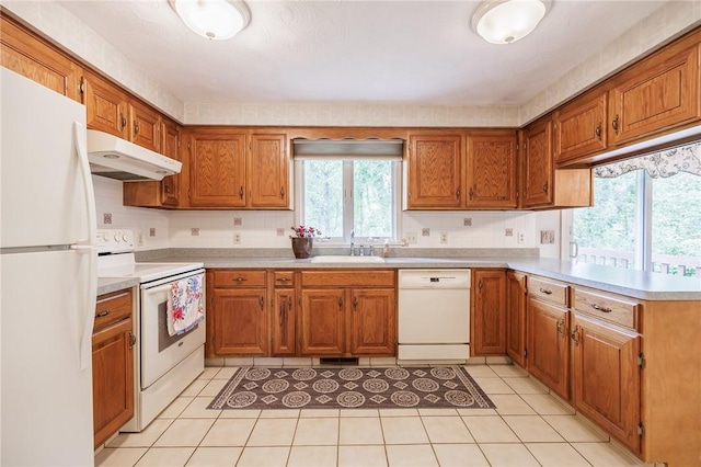 668 Willow Ln, Webster, NY 14580 - kitchen featuring white appliances, under cabinet range hood, a peninsula, and plenty of natural light