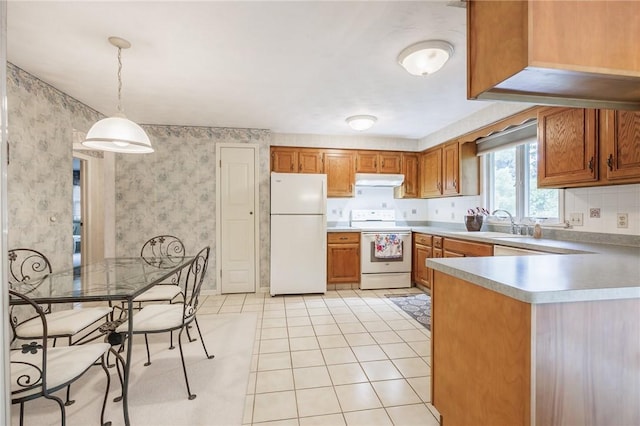 668 Willow Ln, Webster, NY 14580 - kitchen with white appliances, brown cabinetry, wallpapered walls, light countertops, and a peninsula