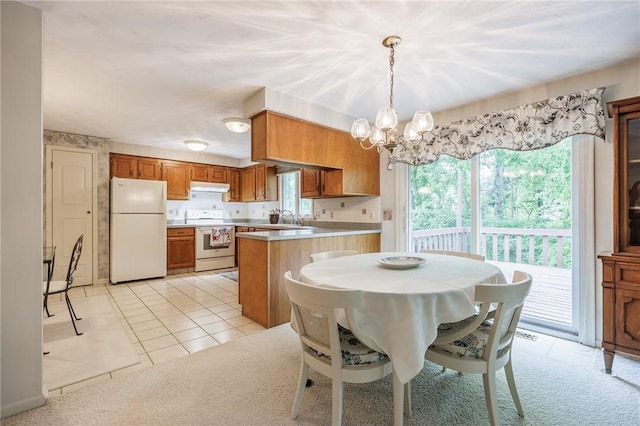 668 Willow Ln, Webster, NY 14580 - dining room with a chandelier, light carpet, and light tile patterned floors