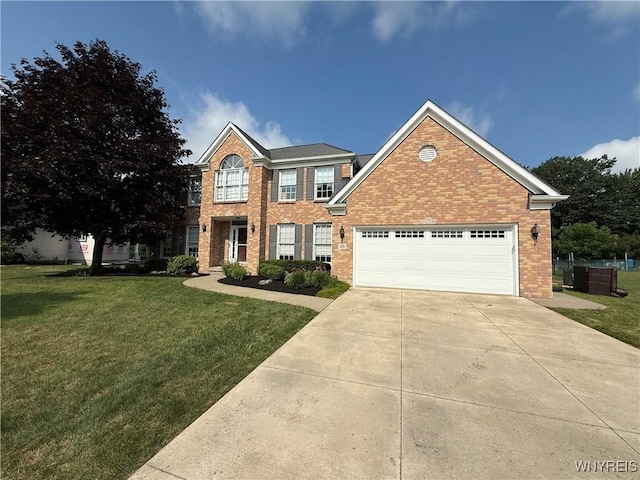 26 Forestglen Cir, Amherst, NY 14221 - view of front of property featuring a front lawn, brick siding, driveway, and an attached garage