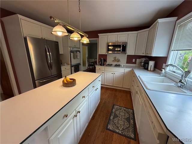 26 Forestglen Cir, Amherst, NY 14221 - kitchen featuring appliances with stainless steel finishes, light countertops, white cabinetry, and dark wood-type flooring