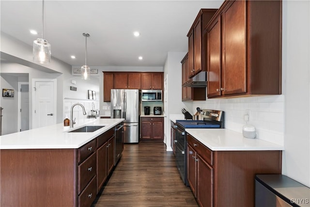 2600 Sunshine Cir, Camillus, NY 13031 - kitchen featuring stainless steel appliances, under cabinet range hood, light countertops, a center island with sink, and backsplash