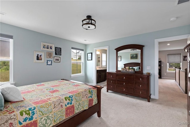 2600 Sunshine Cir, Camillus, NY 13031 - bedroom with multiple windows, light colored carpet, and connected bathroom