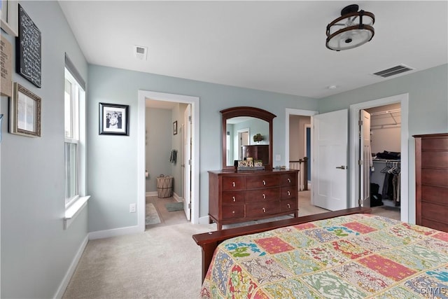 2600 Sunshine Cir, Camillus, NY 13031 - bedroom featuring a spacious closet, light colored carpet, and connected bathroom
