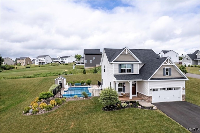 2600 Sunshine Cir, Camillus, NY 13031 - view of front of house with asphalt driveway, stone siding, a residential view, a porch, and roof with shingles
