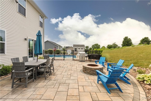 2600 Sunshine Cir, Camillus, NY 13031 - view of patio / terrace with a fire pit, outdoor dining space, area for grilling, and an outdoor structure