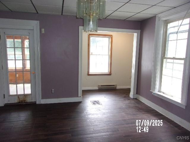 20 N 4th Ave, German Flatts, NY 13357 - unfurnished dining area featuring a baseboard radiator, a drop ceiling, plenty of natural light, wood finished floors, and a chandelier