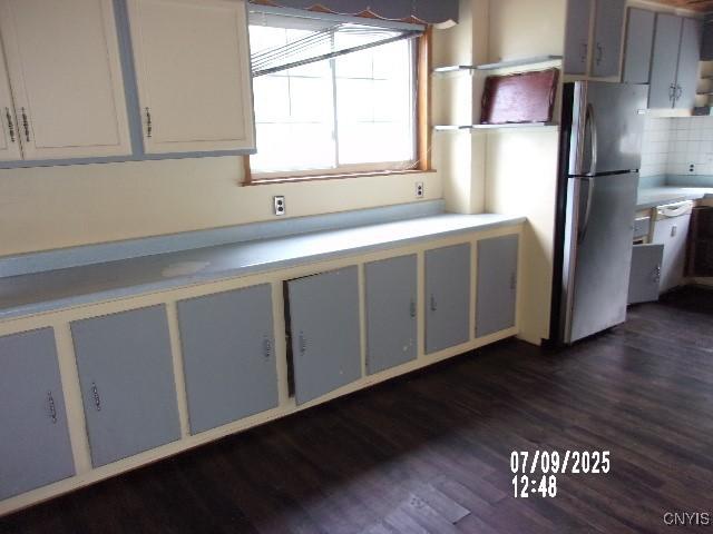 20 N 4th Ave, German Flatts, NY 13357 - kitchen featuring freestanding refrigerator, dark wood-style flooring, light countertops, decorative backsplash, and open shelves