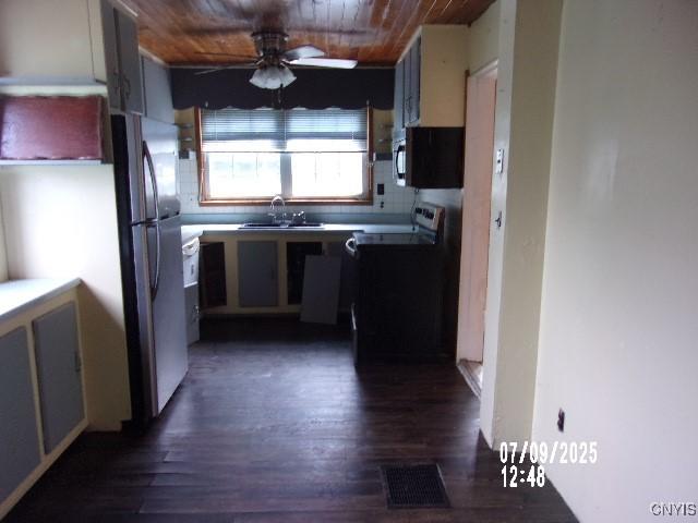20 N 4th Ave, German Flatts, NY 13357 - kitchen featuring range, freestanding refrigerator, black microwave, wooden ceiling, and ceiling fan