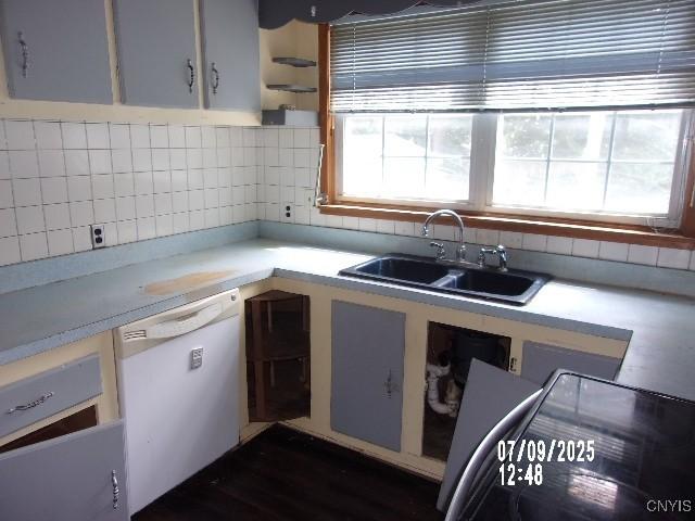 20 N 4th Ave, German Flatts, NY 13357 - kitchen featuring white dishwasher, tasteful backsplash, light countertops, and white cabinets